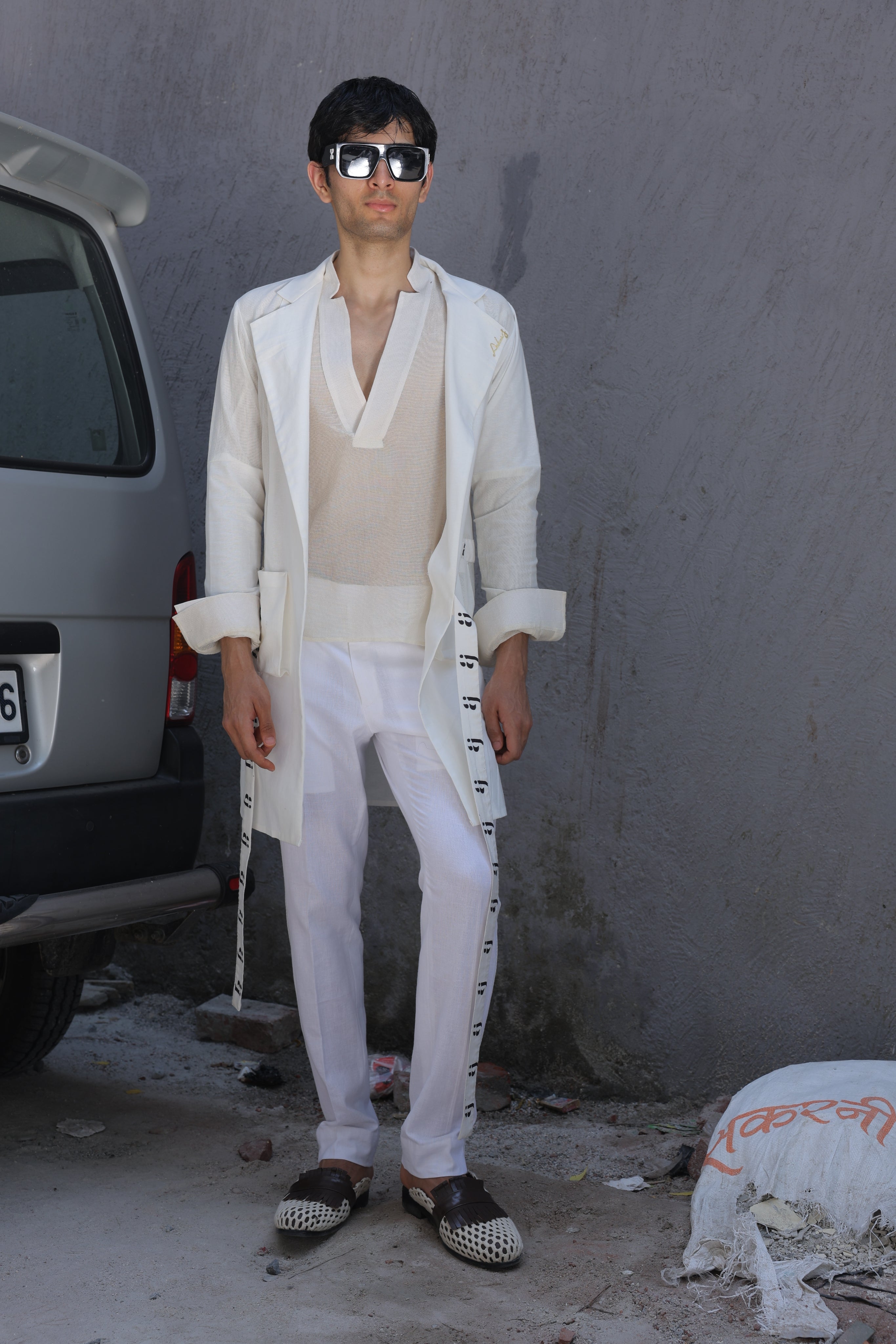 White overlay with AJ logo printed belt paired with shirt and pants