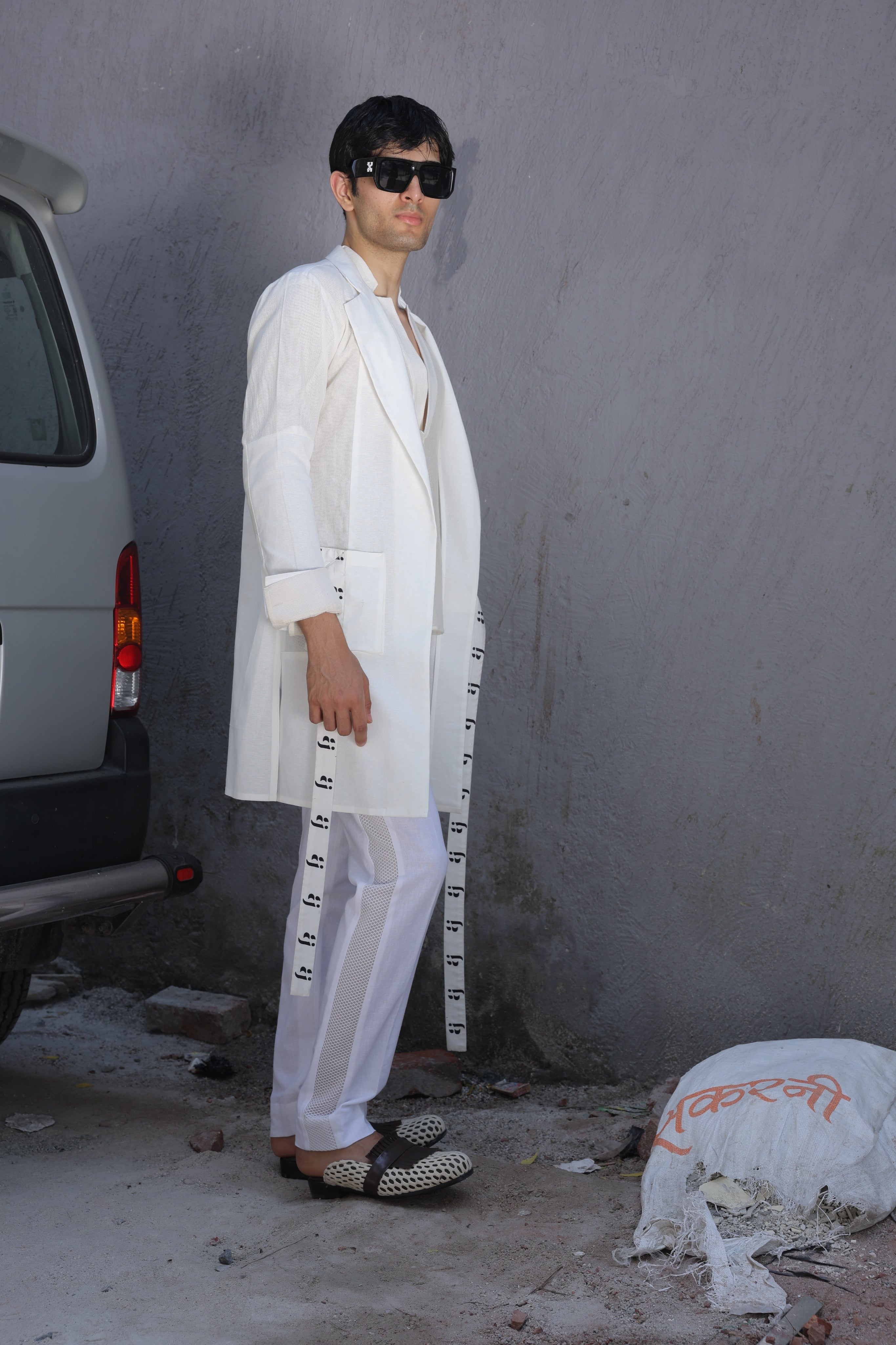 White overlay with AJ logo printed belt paired with shirt and pants