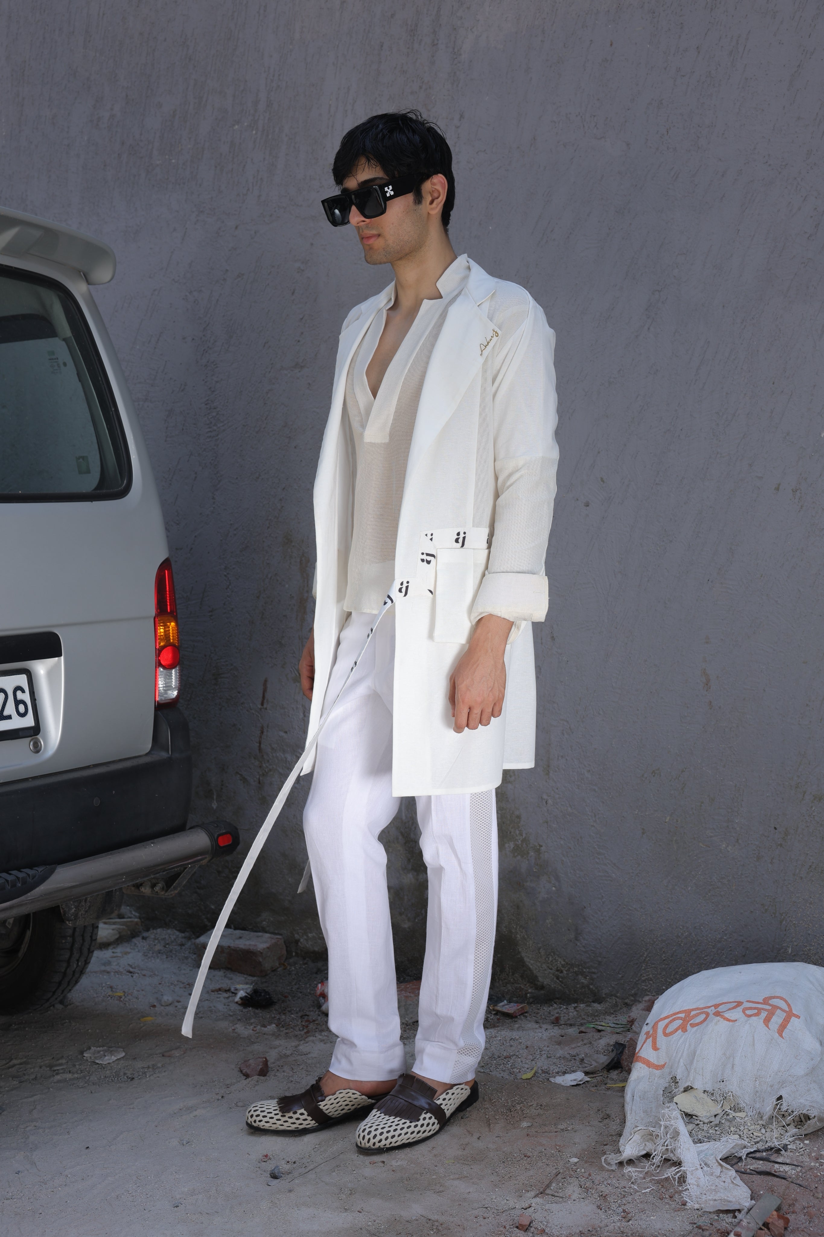 White overlay with AJ logo printed belt paired with shirt and pants