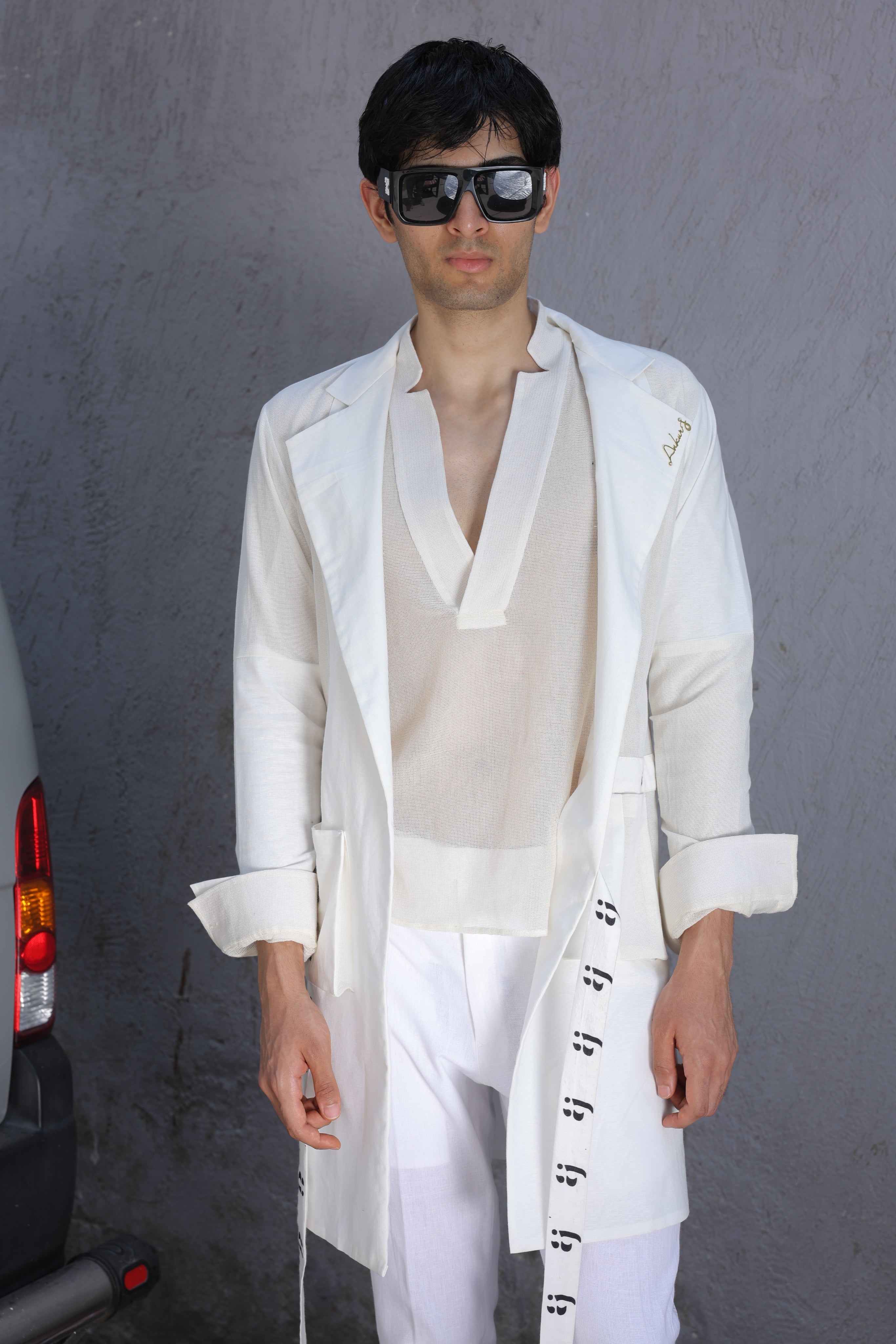 White overlay with AJ logo printed belt paired with shirt and pants