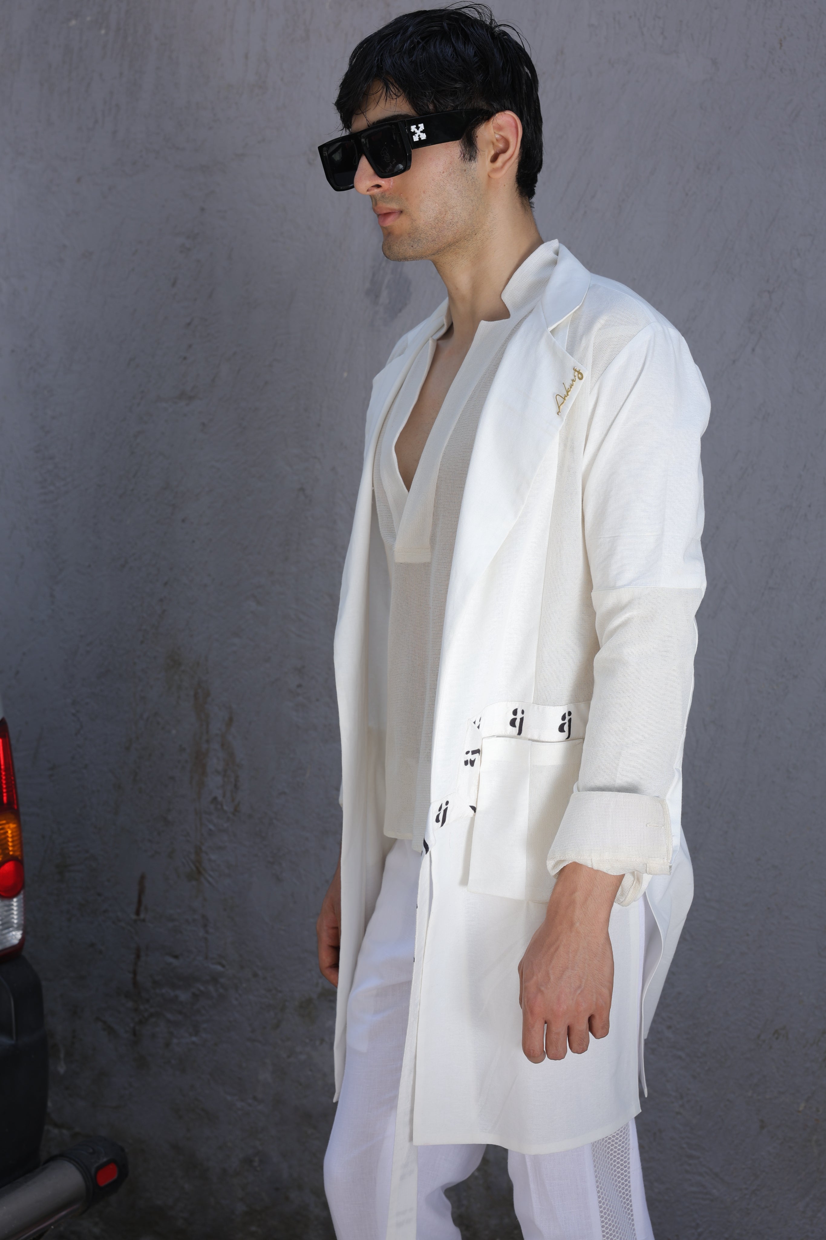 White overlay with AJ logo printed belt paired with shirt and pants