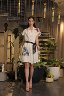 Off white crochet overlay dress with a belt and graphic printed pockets